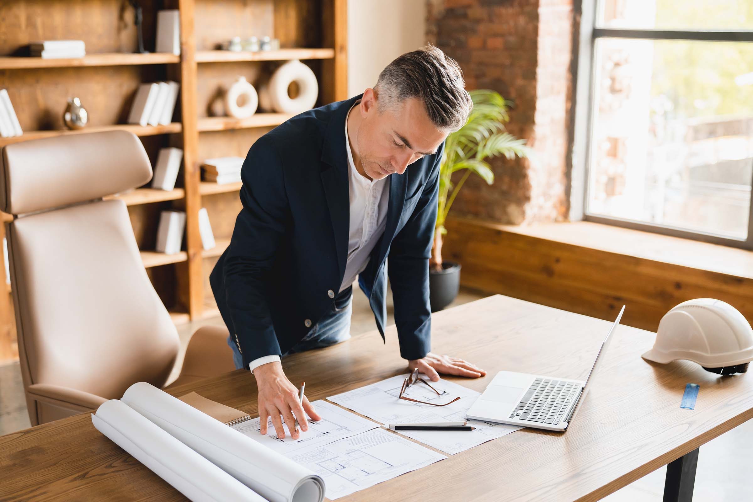 architect-working-in-office-with-blueprints-inspe-8T5QQ2W.jpg